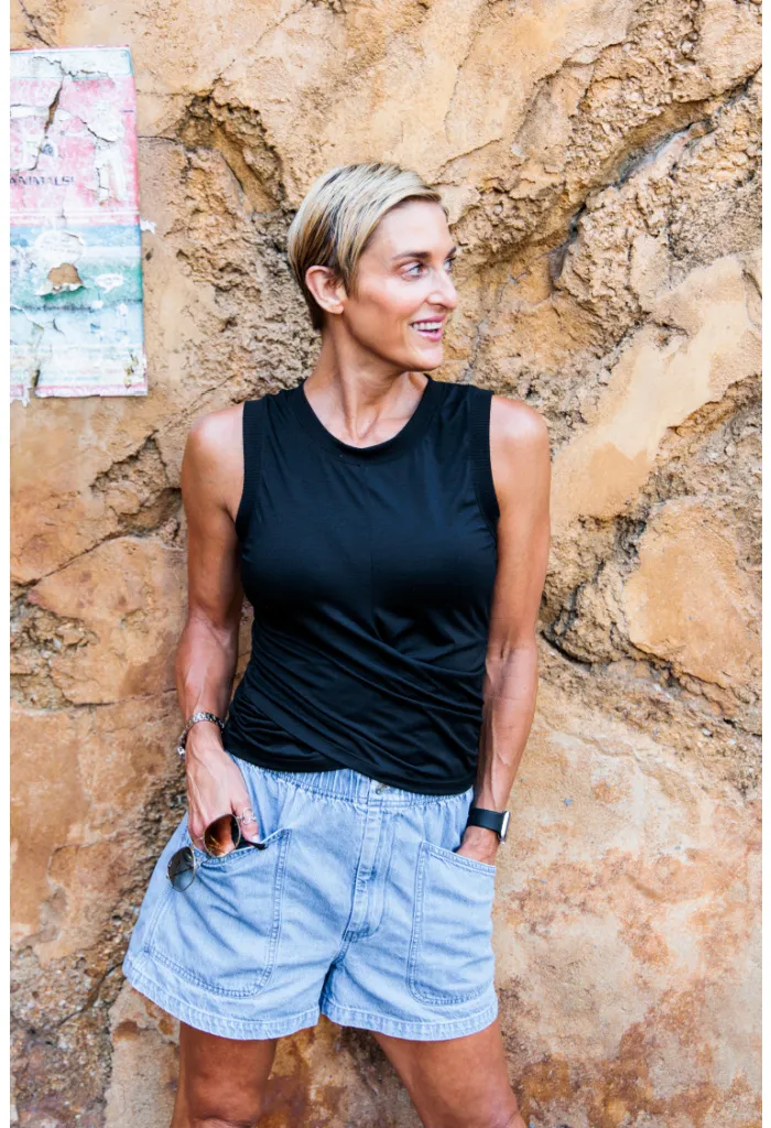 Julie Voris standing against a cement wall