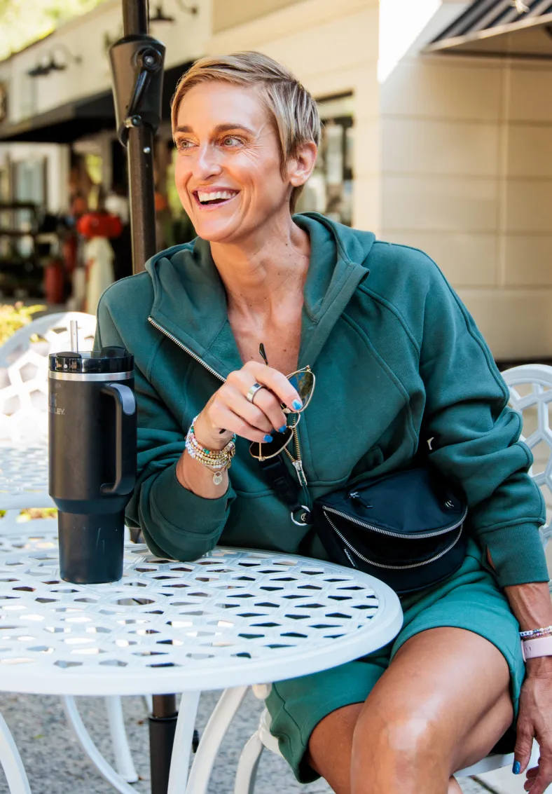 Julie Voris sitting at table outside with water jug